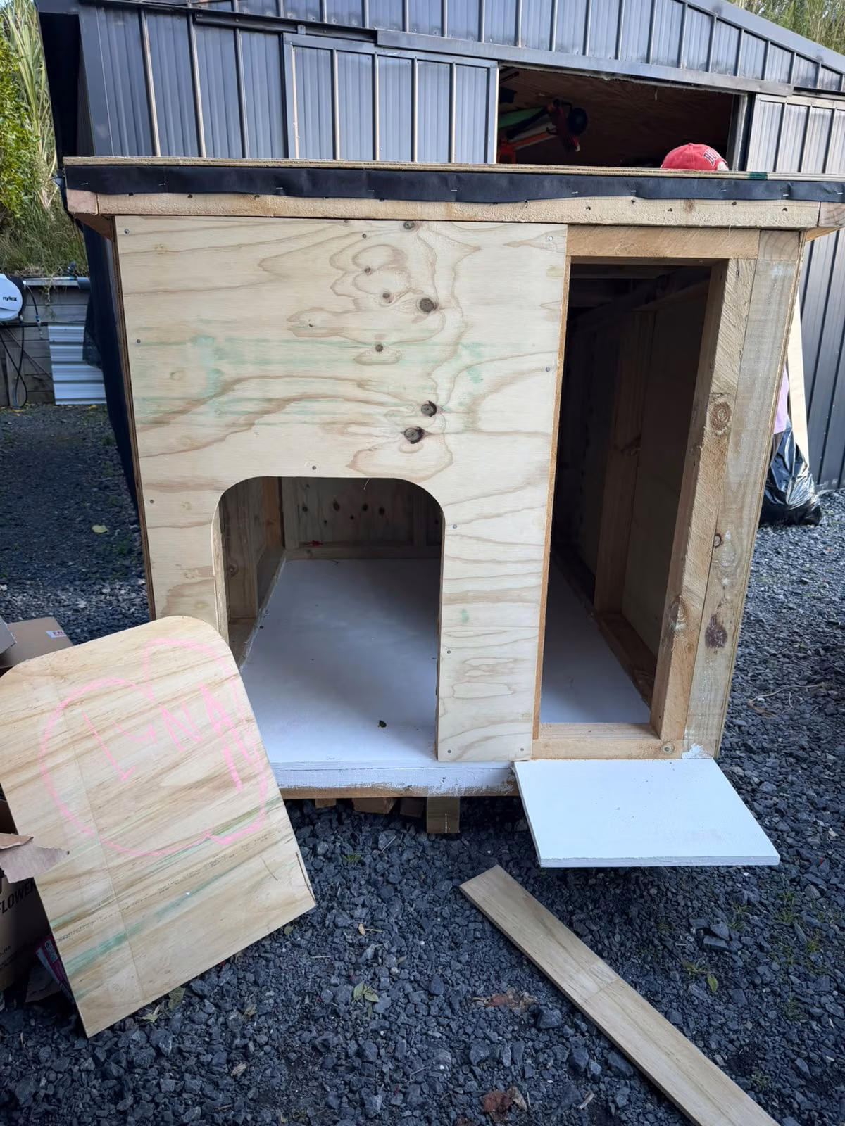 The kennel shell with Luna's doorway and the external feeder compartment beside it