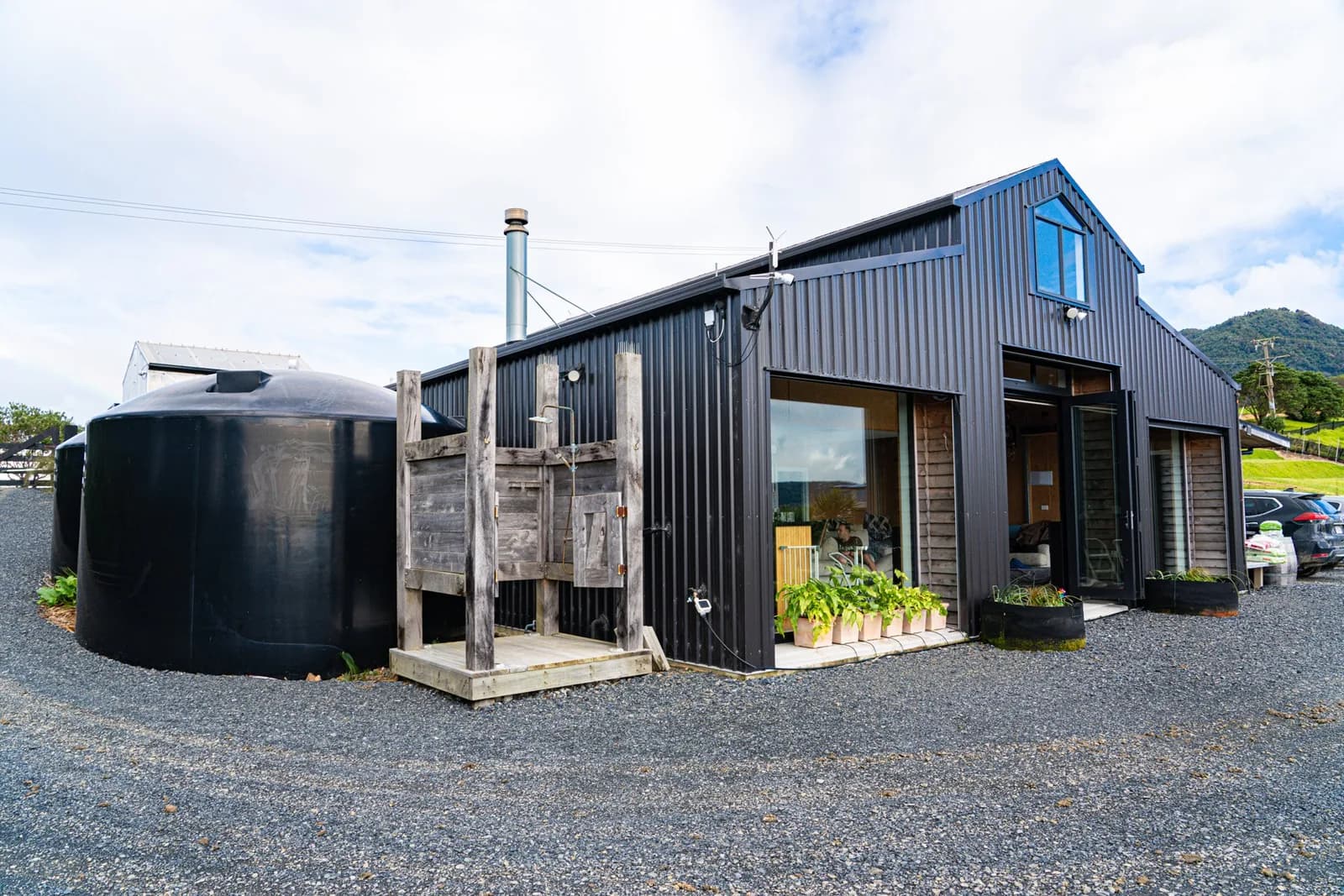 Our rainwater tanks, outdoor shower and barn